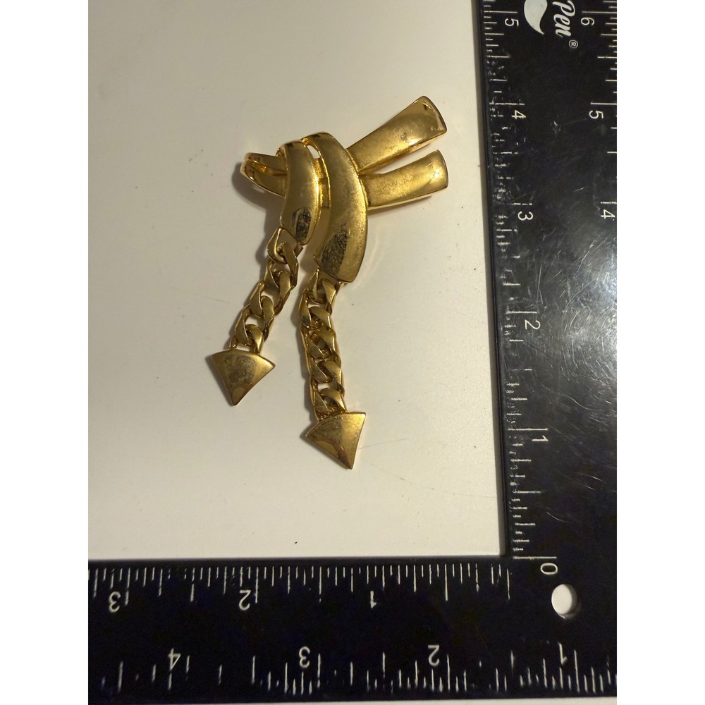 Gold Tone Ribbon Knot Brooch with Dangle Curb Chains and Triangle Charms